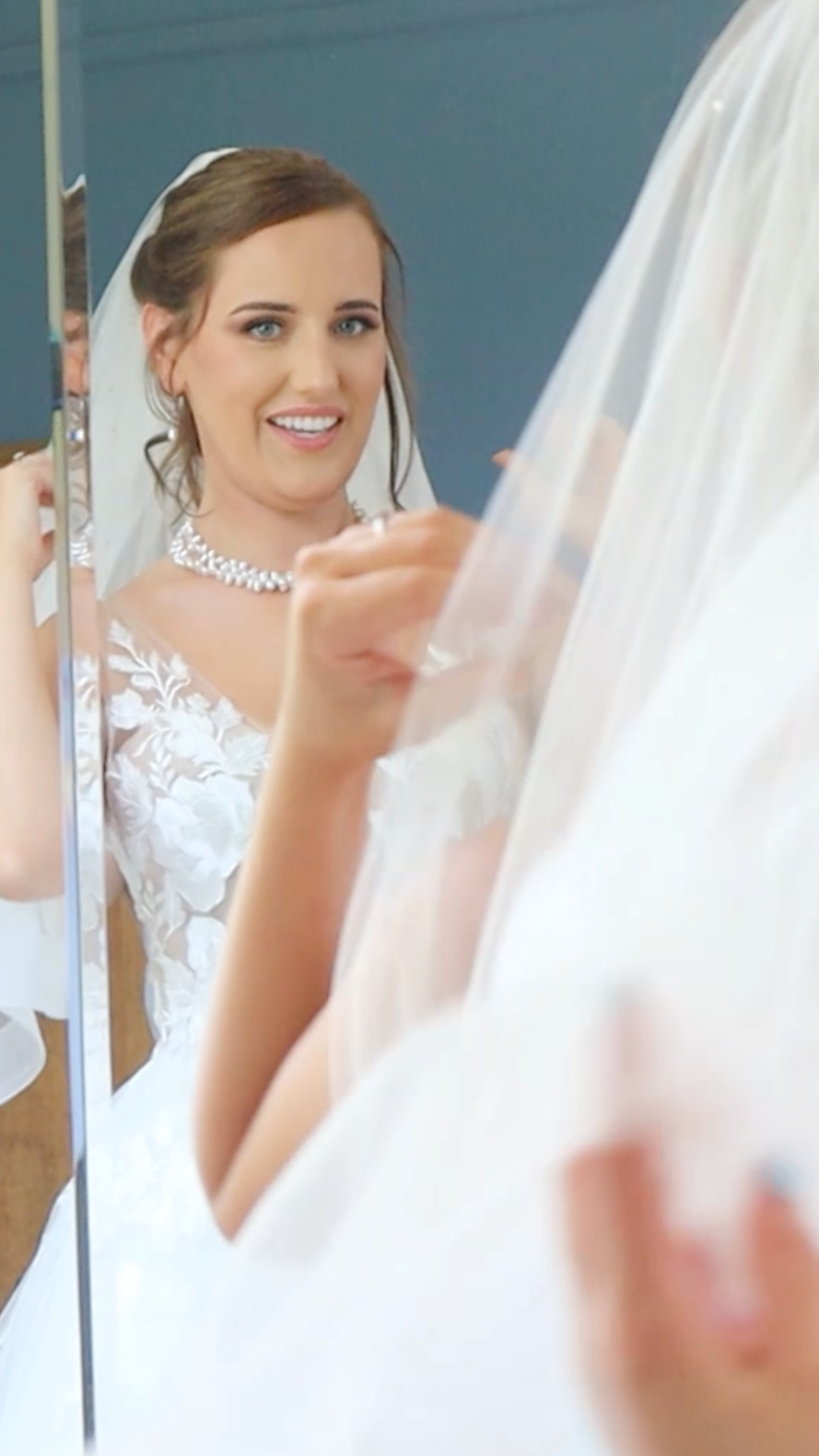 Picture of Bride looking in the mirror getting ready for her Wedding